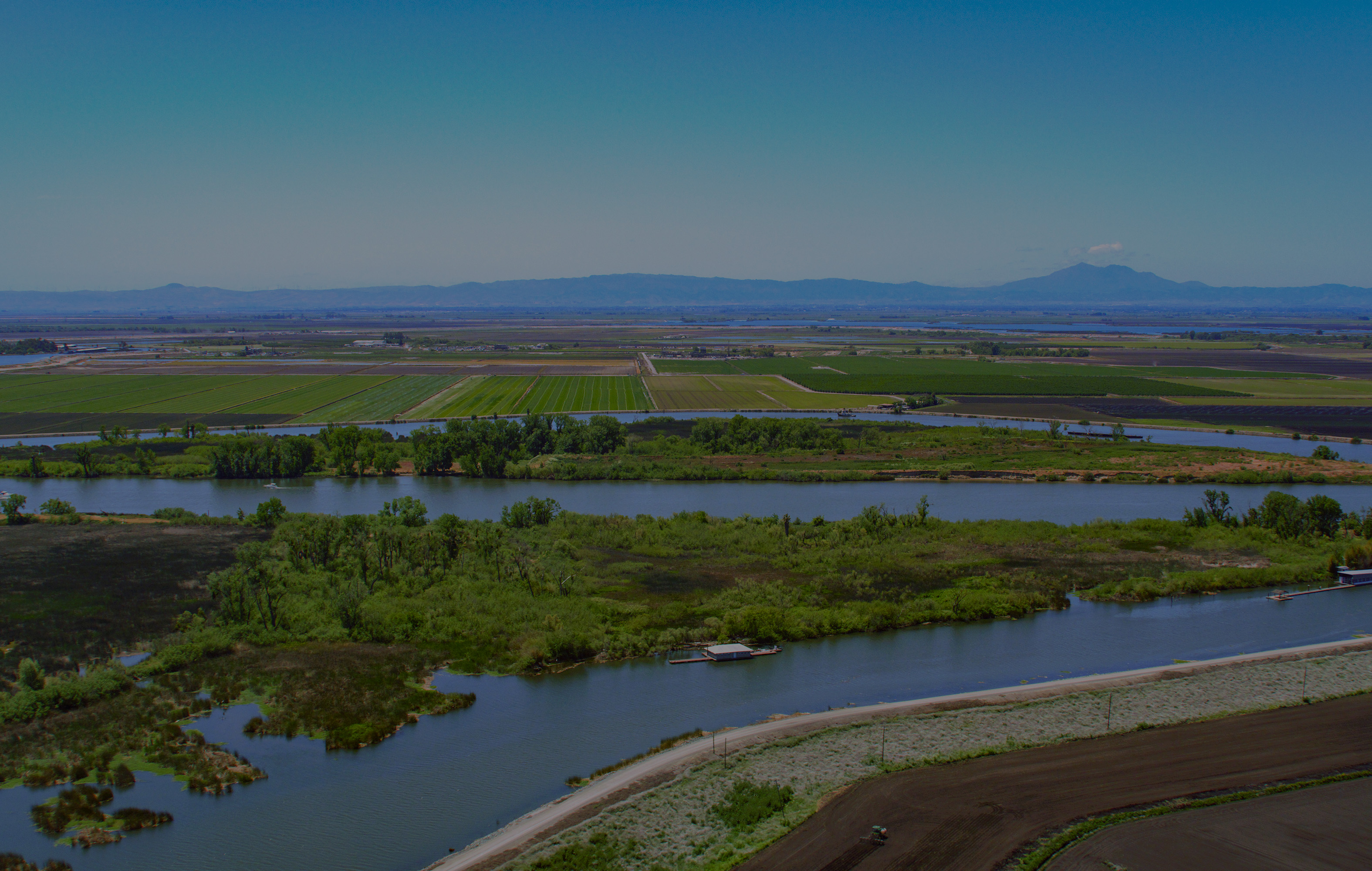 Aerial view looking south west at a section of the San Joaquin River and Weder Point Yacht Club on Hog Island behind is Spud Island, both part of the Sacramento-San Joaquin River Delta in San Joaquin County, California. Photo taken May 11, 2023.