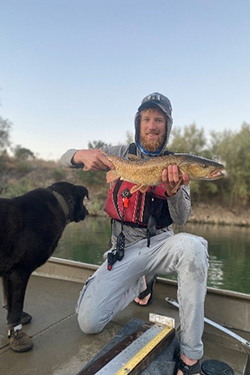 2021 Bay-Delta Science Conference oral presentation first place awardee Dylan K. Stompe holding a fish.