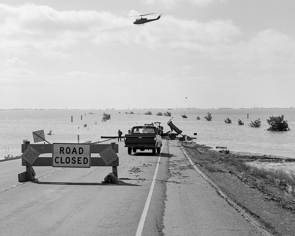 A photo from the California Department of Water Resources of Highway 12 just east of the Rio Vista Bridge was blocked by floodwaters after a levee failed in the vicinity of the Spindrift Marina on June 21, 1972 in the Brannan-Andrus Levee Maintenance District. A Federal Disaster was declared on June 27 within the Sacramento-San Joaquin Delta region. The levee repair was conducted by the U.S. Army Crops of Engineers and the breach was closed on July 26. Photo taken June 23, 1972.
