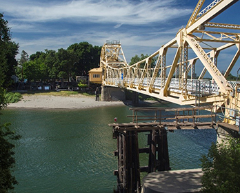 A yellow steel bridge spanning the Sacramento River near Isleton, California.