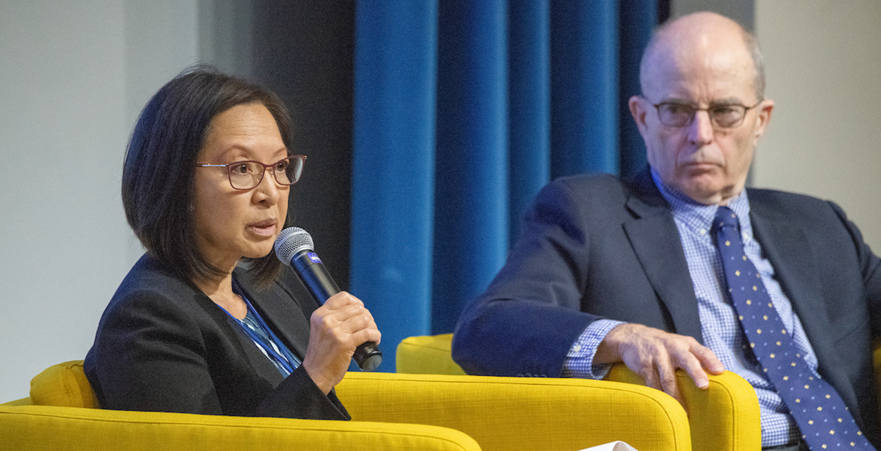 Delta Stewardship Council Chair Susan Tatayon sits in a yellow chair and speaks into a microphone during a September 2019 Climate Adaptation Forum in Sacramento.