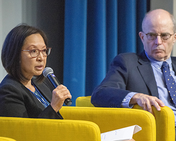Delta Stewardship Council Chair Susan Tatayon sits in a yellow chair and speaks into a microphone during a September 2019 Climate Adaptation Forum in Sacramento.